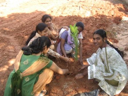Girls planting a Tree Girls student